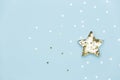 Christmas star made with mold for the cookies and gold sparkling stars on blue background.Holidays and Christmas concept Royalty Free Stock Photo