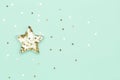 Christmas star made with mold for the cookies and gold sparkling stars on green background. Flat lay. Holidays Royalty Free Stock Photo