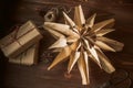 Christmas star made from paper bags, on a wooden table with gift boxes in craft paper. Reuse concept. Zero waste New Royalty Free Stock Photo