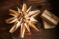 Christmas star made from paper bags, on a wooden table with gift boxes in craft paper. Reuse concept. Zero waste New Royalty Free Stock Photo