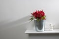 Christmas star, red poinsettia on a white fireplace with a figurine of an angel Royalty Free Stock Photo