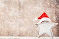 Christmas star with Santa hat. Vintages background