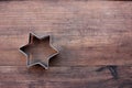 Christmas star shaped cookie cutters on a wooden table. Christmas background. Royalty Free Stock Photo