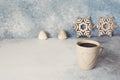 Christmas stars, candles and cuo of coffee on a blue stone background