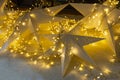 Christmas start with lights background. Nativity star, blurred lights, indoor and outdoor decorations for new year Royalty Free Stock Photo