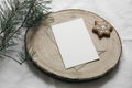 Christmas stationery. Blank greeting card, invitation mockup on cut wooden round board with star gingerbread cookie