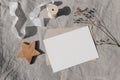 Christmas stationery. Blank greeting card, invitation mockup. Wooden star ornament, craft envelope and dry grass in Royalty Free Stock Photo