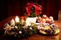 Christmas still life, advent, with Christmass cookies, apples and decorations, two candles lit Royalty Free Stock Photo
