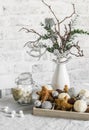 Christmas still life. Box of Christmas decorations, jar of marshmallows, alternative christmas tree on the white kitchen table