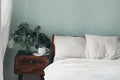 Christmas still life. Cup of coffee, retro wooden bedside table. Pine tree branches and silver stars ornaments in glass