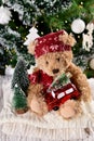 Christmas still life with cute teddy bear holding red car Royalty Free Stock Photo