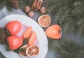 Christmas still life with persimmon and cinnamon with fir-tree on wooden background. Top view. Royalty Free Stock Photo