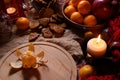 Christmas still life. Gingerbread cookies in a glass jar, tangerines, candles Royalty Free Stock Photo