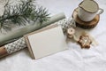 Christmas still life. Greeting card, invitation mockup. Gingerbread cookies, pine tree branches on white linen table