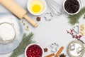 Christmas still life of items for baking cookies. Broken egg in bowl, whisk and sieve, molds, and flour on table Royalty Free Stock Photo