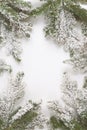 Christmas still life. Spruce branches form a frame with white copespace in the middle