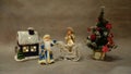 Christmas still life, toys Santa Claus and snow maiden violinist near the Christmas tree Royalty Free Stock Photo