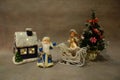 Christmas still life, toys Santa Claus and snow maiden violinist near the Christmas tree Royalty Free Stock Photo