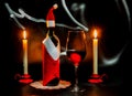 Christmas still life with a wine bottle, candles and a wine glass Royalty Free Stock Photo
