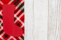 Christmas stocking on buffalo plaid border material holiday background on weathered wood Royalty Free Stock Photo