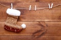 Christmas stocking sock hanging on brown wooden background, merry xmas and happy New year card, copy space, top view Royalty Free Stock Photo