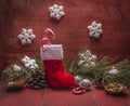 Christmas stocking Pine cones and branches snowflake and candy Christmas decorations red wooden rustic background close up Royalty Free Stock Photo