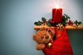 Christmas stocking with presents candle and holly. Royalty Free Stock Photo