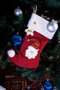 Christmas stocking. Red sock with snowflakes for Santa\'s gifts hanging on the Christmas tree. Winter holidays Royalty Free Stock Photo