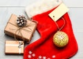 Christmas stocking sock shaped bag fill with presents. Attributes of christmas. Santa stocking with christmas gift box Royalty Free Stock Photo