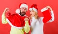 Christmas stocking tradition. Christmas celebration concept. Woman and bearded man in santa hat waiting christmas red