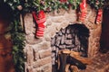Christmas stockings hanging over a fireplace with candles on the mantlepiece. Royalty Free Stock Photo