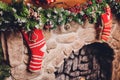 Christmas stockings hanging over a fireplace with candles on the mantlepiece. Royalty Free Stock Photo