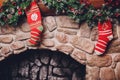 Christmas stockings hanging over a fireplace with candles on the mantlepiece. Royalty Free Stock Photo