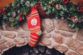 Christmas stockings hanging over a fireplace with candles on the mantlepiece. Royalty Free Stock Photo