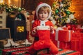 Christmas stockings, Little boy with Christmas presents in sock. Happy new year. Indoor. Merry and bright christmas Royalty Free Stock Photo