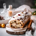 Christmas stollen cake with raisins and dried cranberries on a gray background