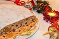 Christmas stollen, candied fruit, candle and decorations.