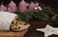 Christmas stollen, cupcake on a wooden table near candles, tree branches and New Year`s toys. Traditional christmas pastries Royalty Free Stock Photo