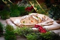 Christmas stollen its a Traditional Dresdner German Christmas cake Stollen with raising, berries and nuts. Sliced stollen on paper