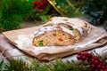 Christmas stollen its a Traditional Dresdner German Christmas cake Stollen with raising, berries and nuts. Sliced stollen on paper