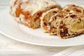 Christmas stollen on plate on white wooden table close up