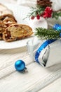 Christmas stollen on plate on white wooden table close up
