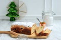 Christmas Stollen. Traditional Sweet Fruit Loaf German Bread with Icing Sugar. Xmas Holiday Table Setting, Decorated with Mini