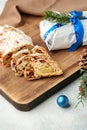 Christmas stollen on wooden cutting board close up on table