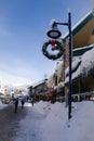 A Christmas Story in the Village of Whistler. Snowy buildings - on the roofs, ski resort. A cold but clear sunny winter day.