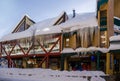 A Christmas Story in the Village of Whistler. Snowy buildings - on the roofs, ski resort. A cold but clear sunny winter day. Royalty Free Stock Photo