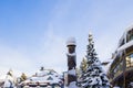 A Christmas Story in the Village of Whistler. Snowy buildings - on the roofs, ski resort. A cold but clear sunny winter day. Royalty Free Stock Photo