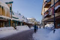 A Christmas Story in the Village of Whistler. Snowy buildings - on the roofs, ski resort. A cold but clear sunny winter day. Royalty Free Stock Photo