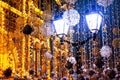 Christmas street decoration. Old lanterns and garlands, fabulous lighting Royalty Free Stock Photo