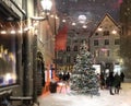 Christmas street illuminated  evening winter in medieval city street ,lantern light blurred in shop windows vitrines , night sky f Royalty Free Stock Photo